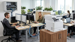 Network printer linked to multiple office workstations through a central Ethernet switch with connecting cables.